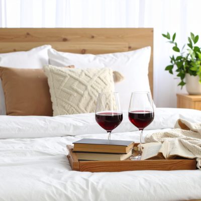 Firefly_Cozy minimalist bedroom with a light wooden bed and white linen bedding. MAKmade thro 698103